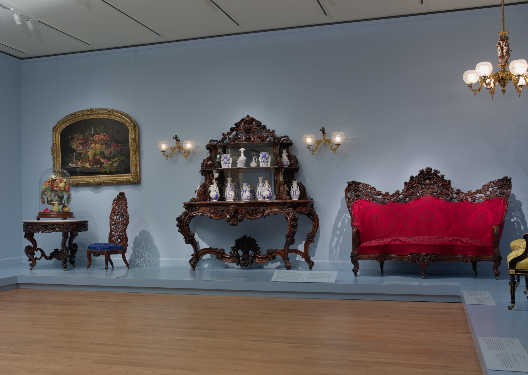 The Belter sofa at right in a Met gallery installation with other furniture; this is a museum arrangement, not its original parlour.