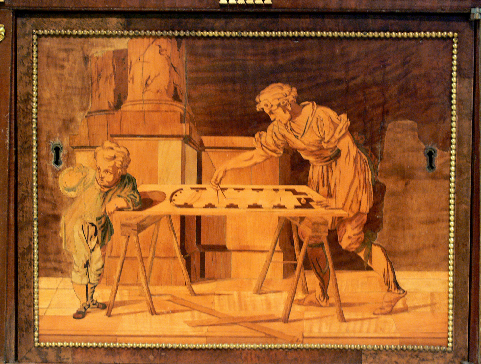 Marquetry panel on the Berlin cabinet showing three craftsmen working around a bench with hand tools.