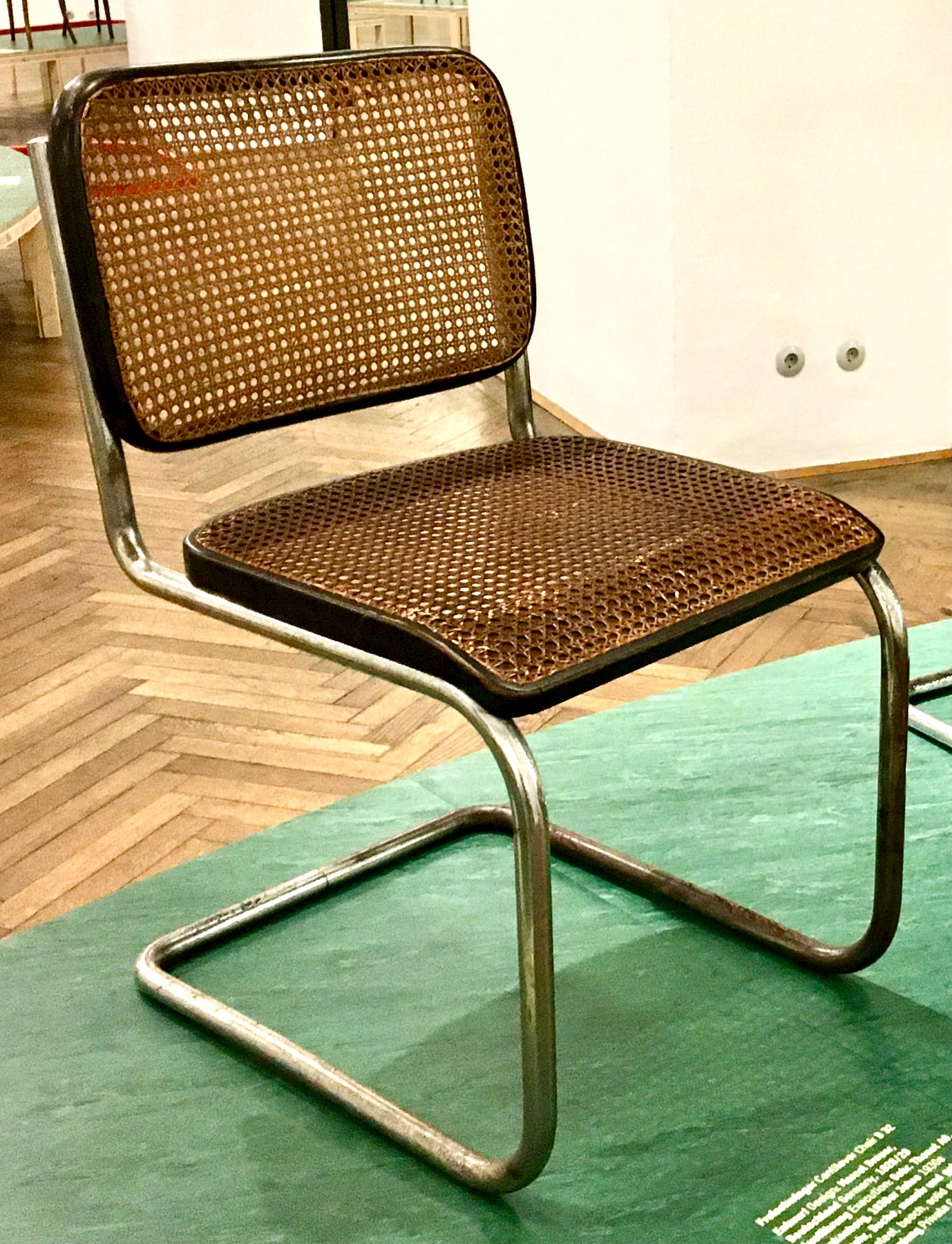 A B32 cantilever chair with cane panels in dark bentwood seat and back frames, carried by a continuous tubular steel base.