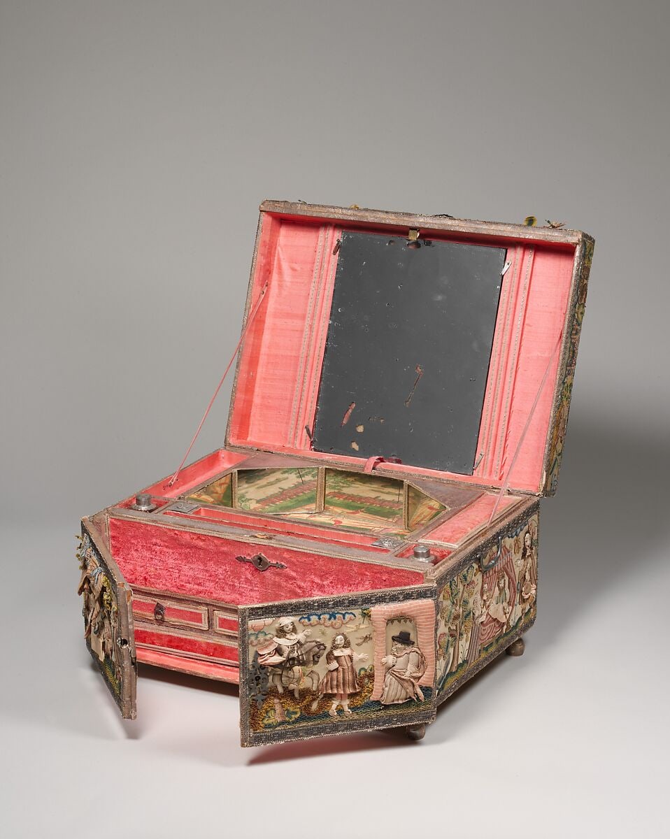 The Esther cabinet open, showing the mirror beneath its lid, a pink-lined writing tray, tiny drawers and reflected landscapes inside.