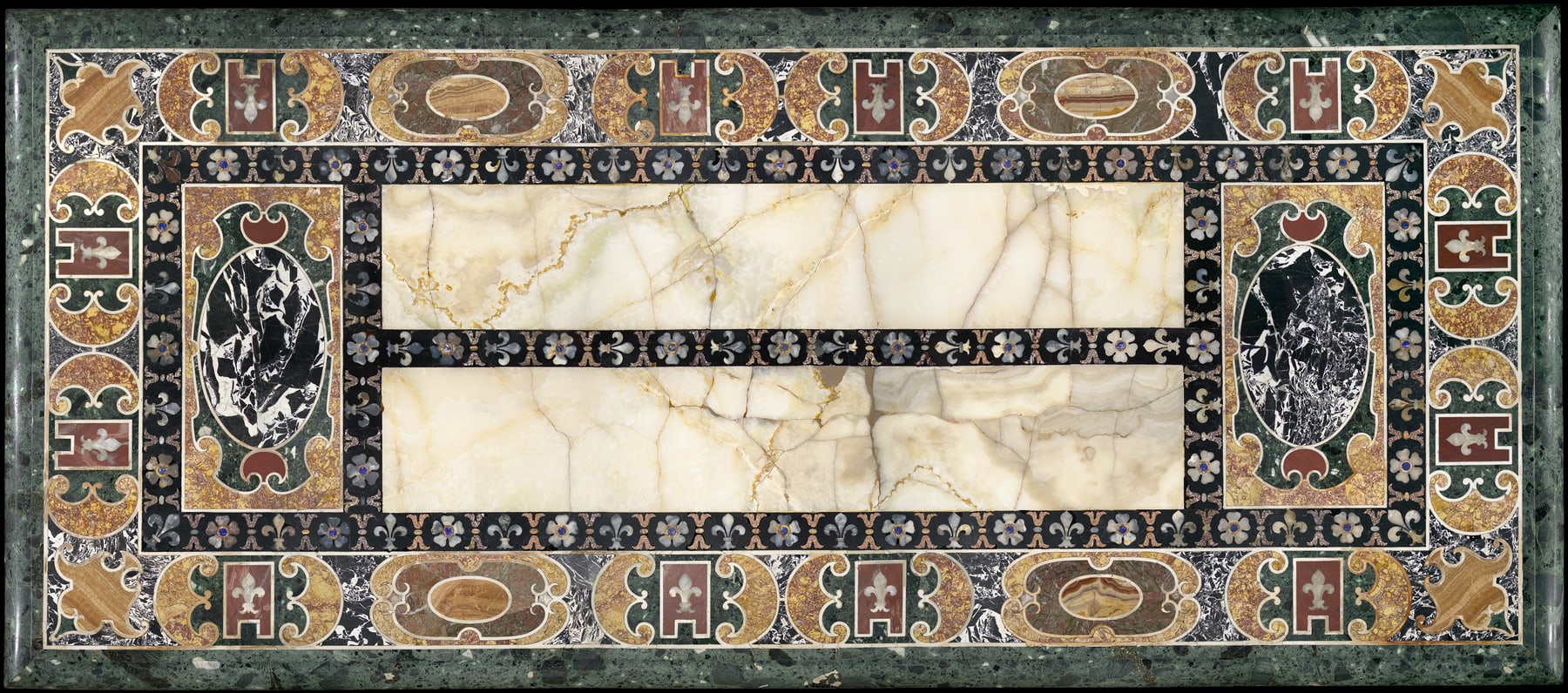 Overhead view of the Farnese tabletop, showing two large alabaster fields within ordered bands and curving stone motifs.