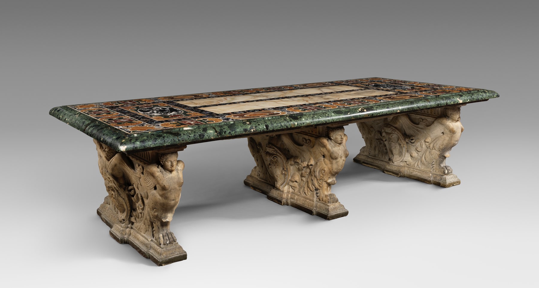 The Farnese Table seen as a whole, with its broad coloured-stone top carried by three carved marble piers.