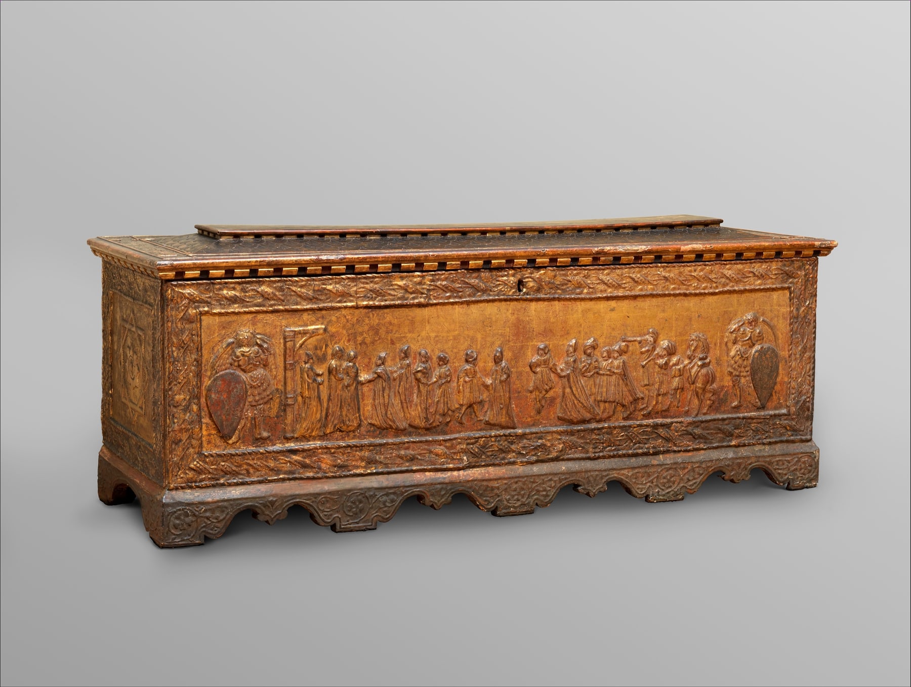 Florentine cassone with a gilded relief procession across its long front and a later replacement lid.