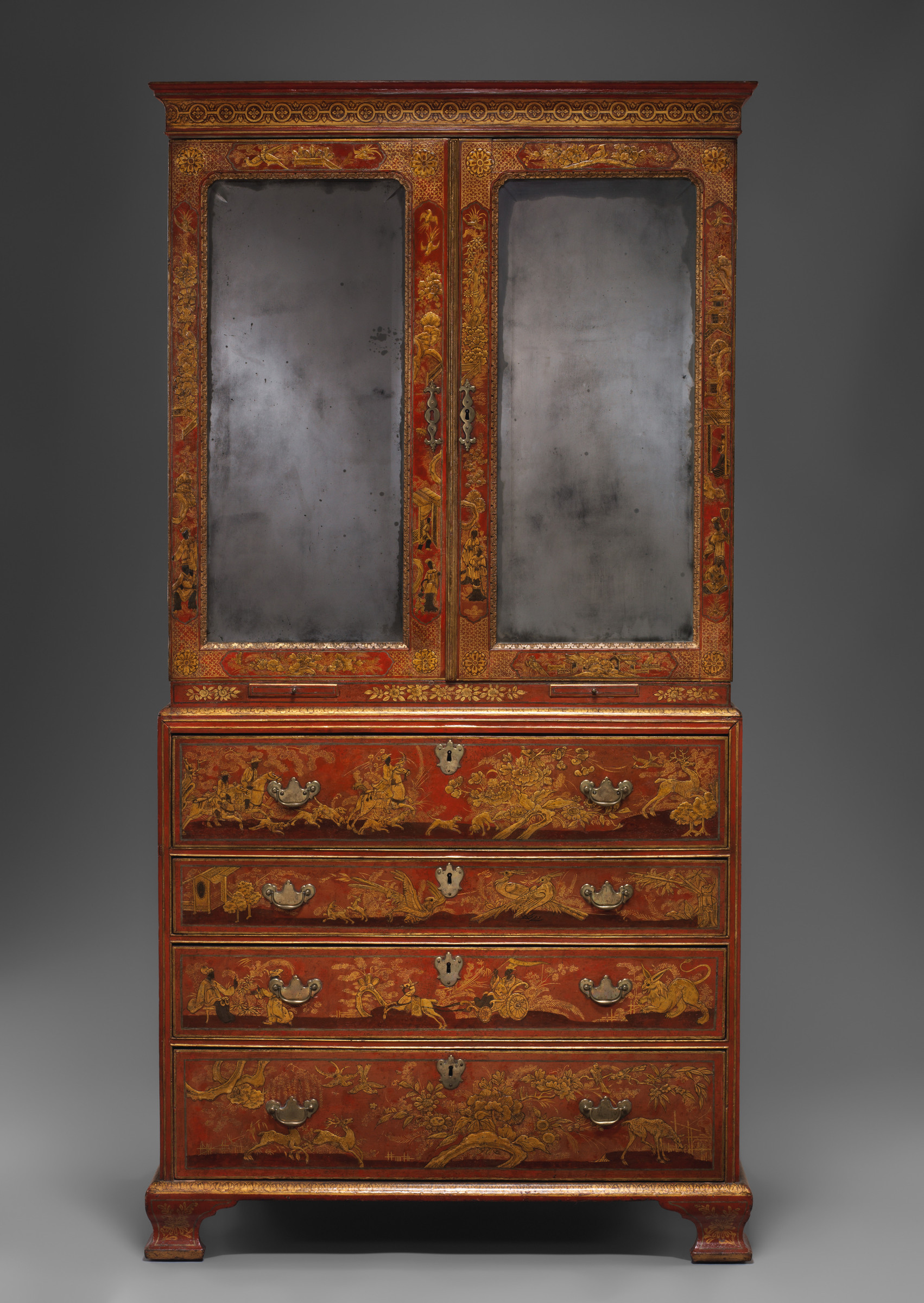 Full frontal view of the same red secretary cabinet closed, with two tall mirrored upper doors above four painted lower drawers.
