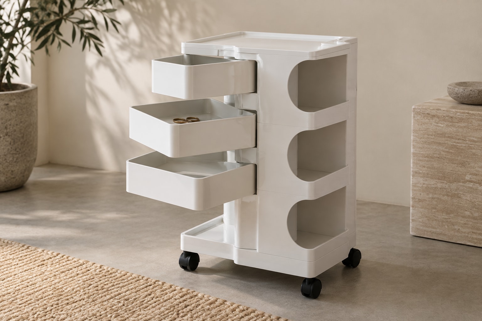 Editorial reconstruction: A compact white wheeled storage trolley with shallow pivoting trays and open compartments beside a desk.
