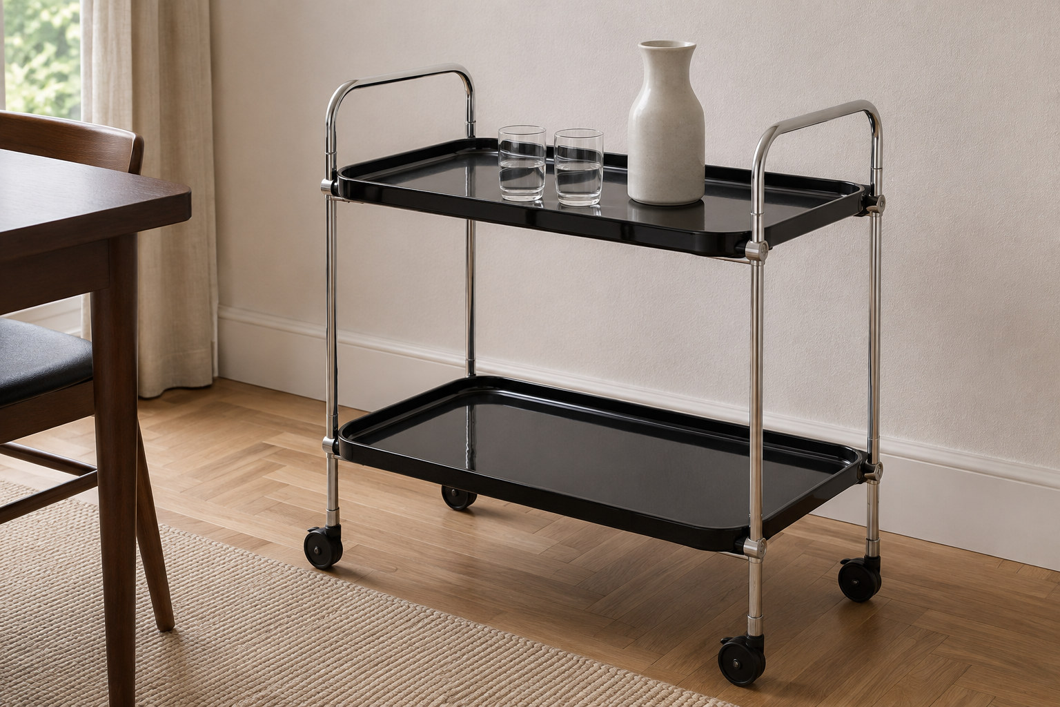 Reconstruction: A black two-tier serving trolley with a slender metal frame, raised handles, four castors and a few glasses.
