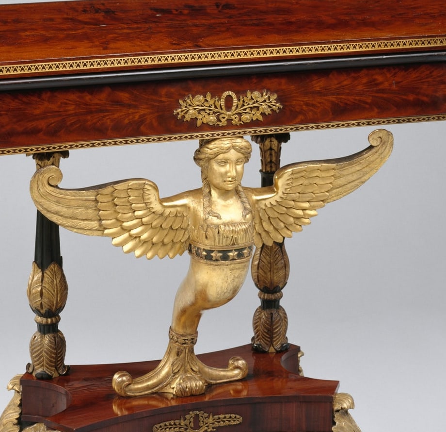 Cropped detail of the folded tabletop edge and winged support; the hidden dated inscription is not visible in this photograph.