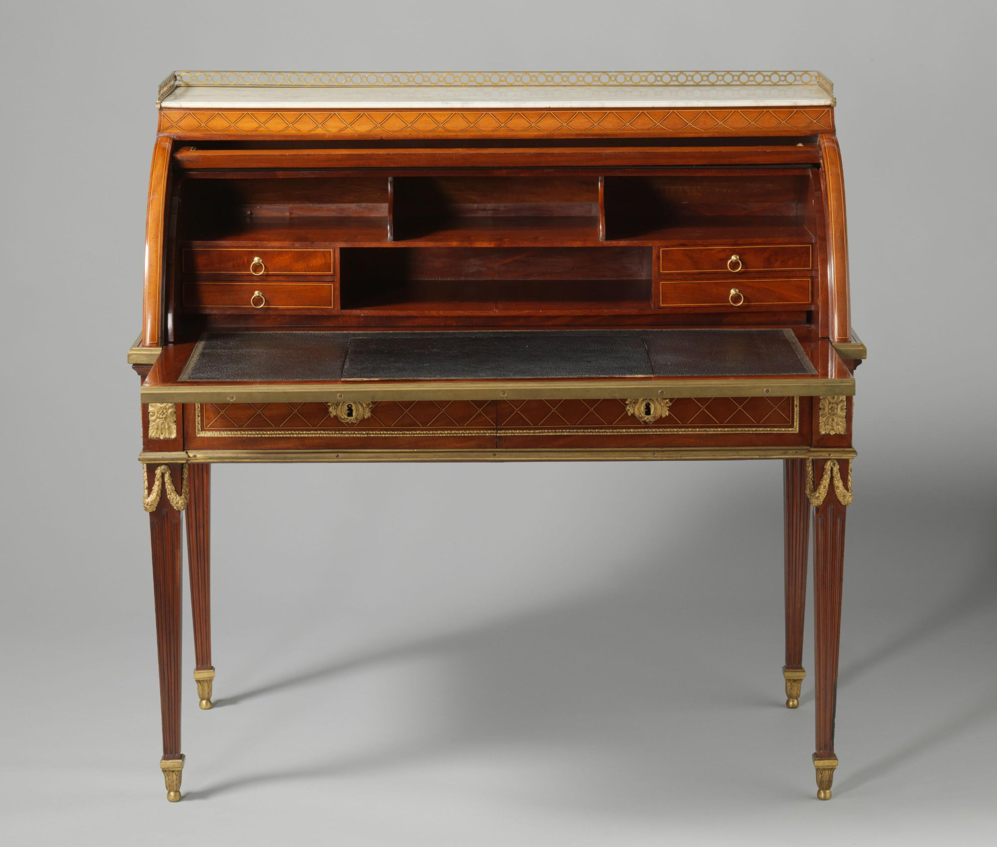Frontal view of the open desk showing three upper compartments, a central shelf, four small drawers and a leather writing surface.