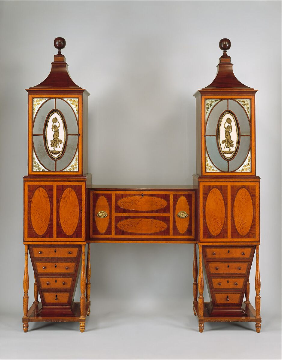 A tall mahogany desk and bookcase with two glazed towers connected by a rectangular desk, leaving open space that forms an H-shaped front.