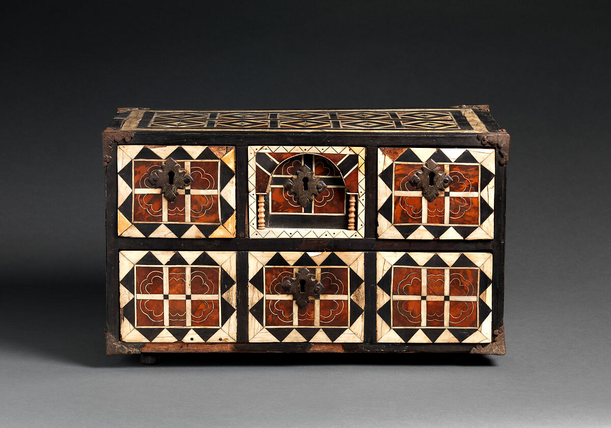 The closed front of the Campeche writing box, showing a central arch, small turned columns, patterned panels and four visible keyholes.