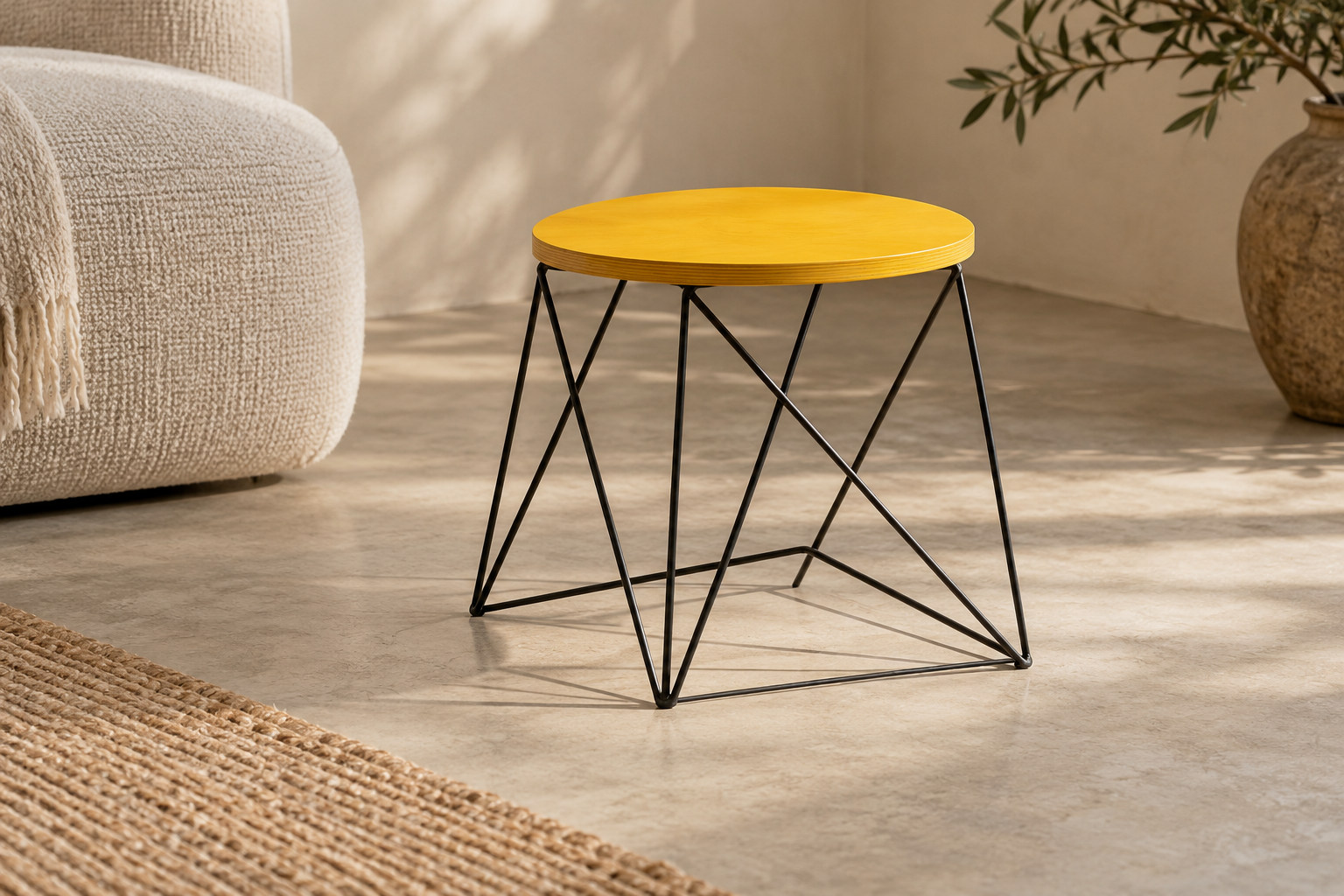 Bright circular top above a very open angular wire-like support in a contemporary colour study.