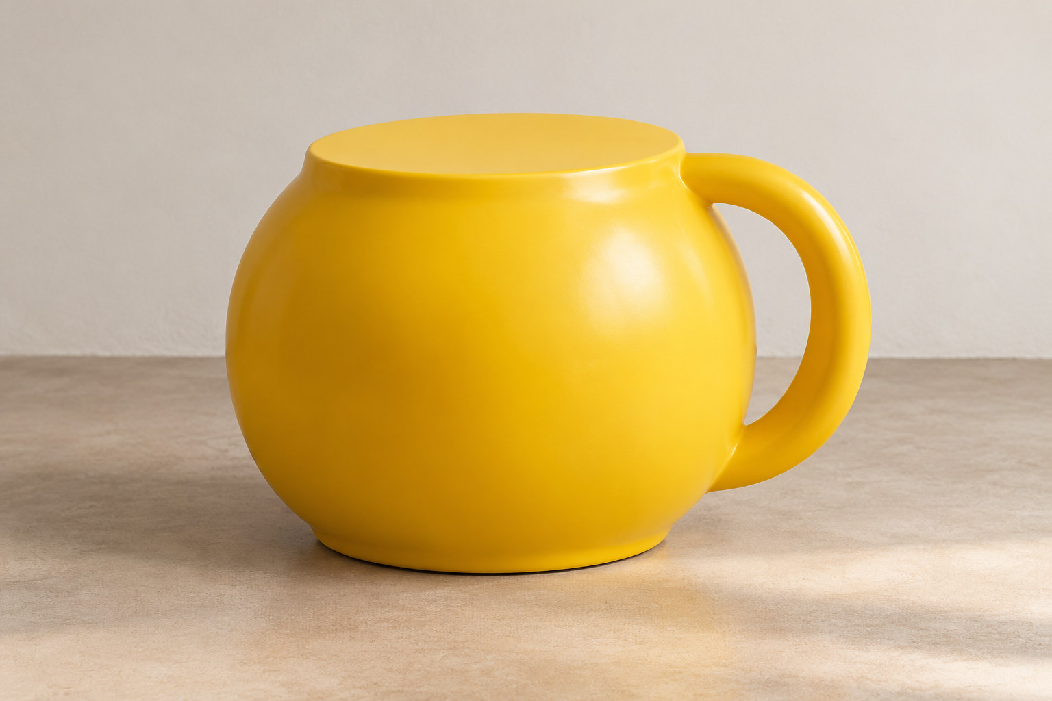 A rounded yellow body has a flat upper face and a large circular handle at one side.