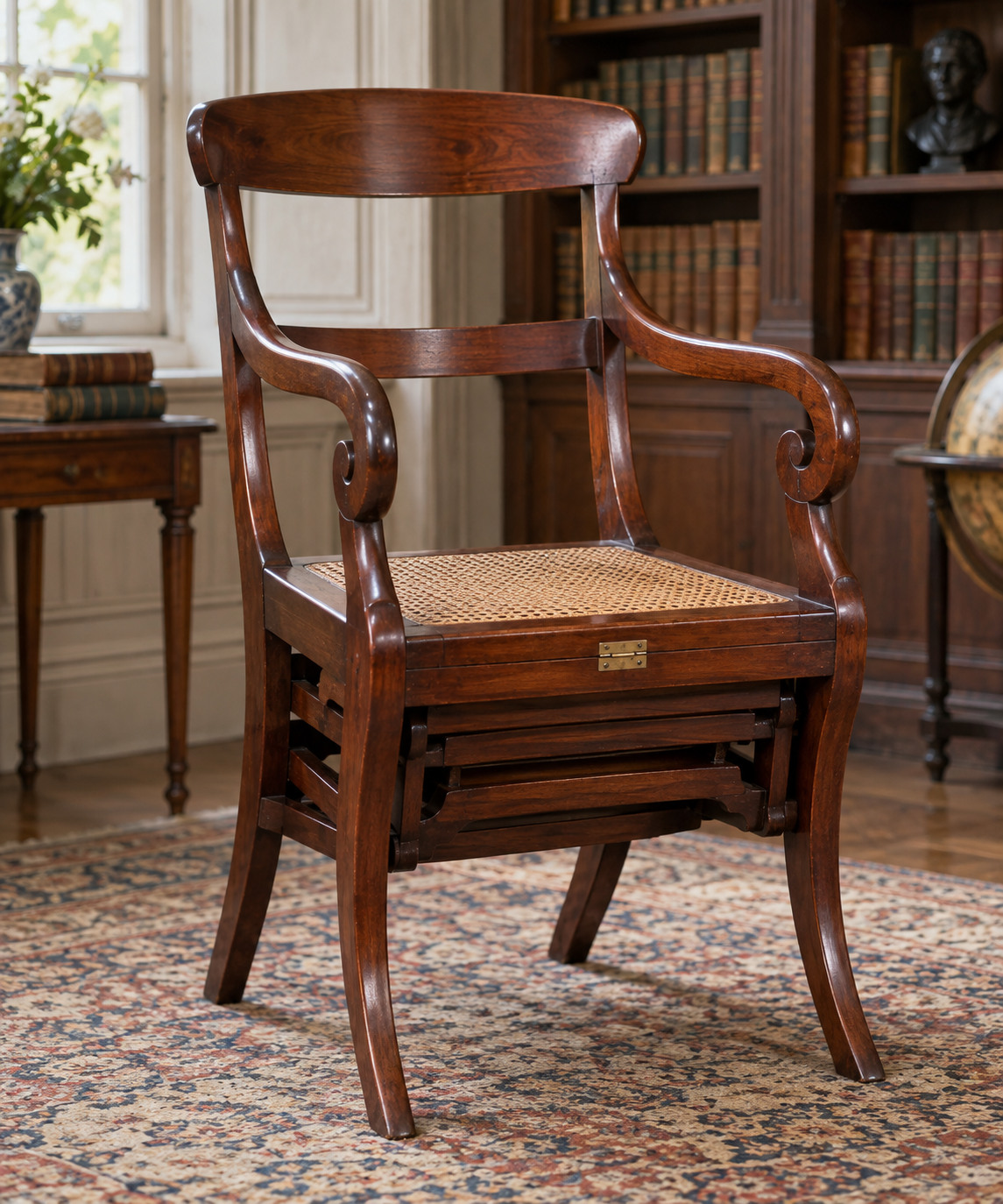 A wooden caned armchair contains additional horizontal components below the seat and a small visible hinge at its front.