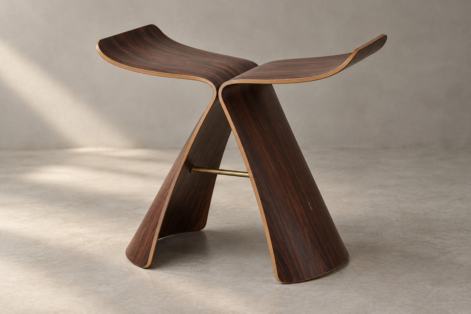 A dark wood stool has two symmetrical curved plywood halves rising into wing-shaped seat edges, joined beneath by a slender horizontal metal connection.