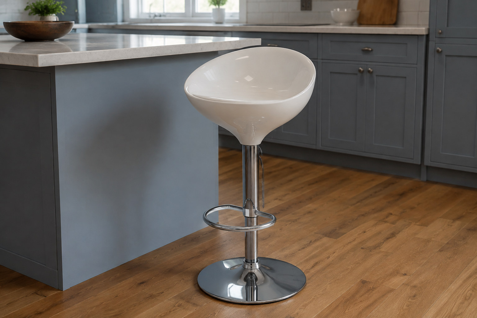 Reconstruction: A glossy white scooped stool seat on a chrome pedestal, with a metal footrest and circular base beside a kitchen counter.