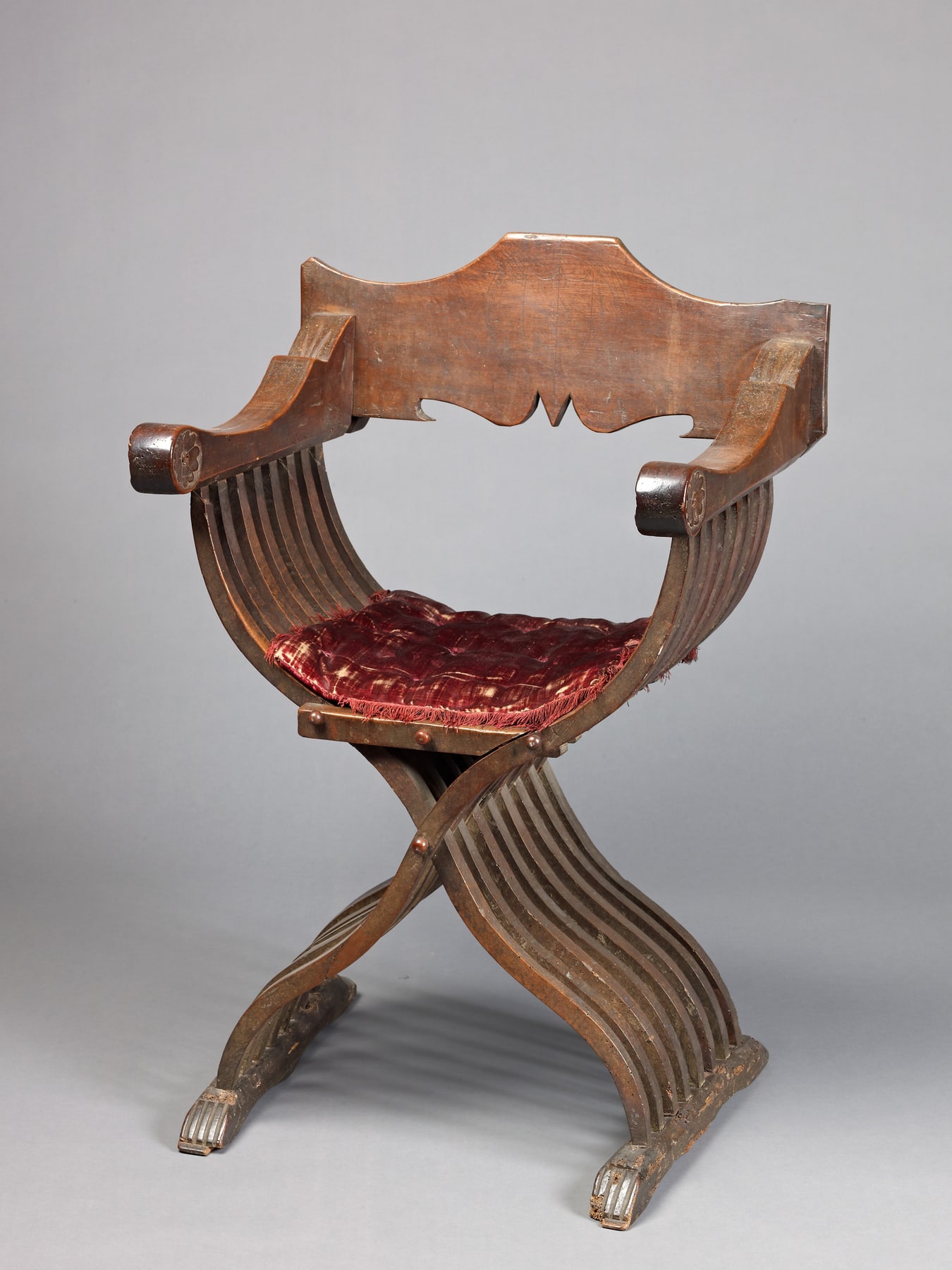 Savonarola chair with curved crossing walnut members and red velvet, catalogued with different dates for the chair and textile.