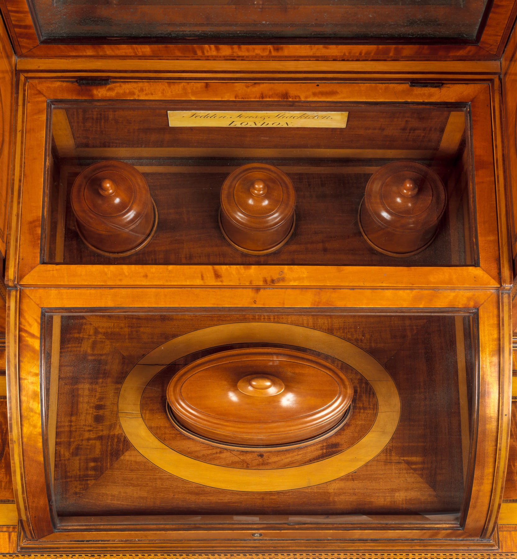 Open compartment of Seddon’s dressing table, showing fitted lidded containers beneath the mirror.