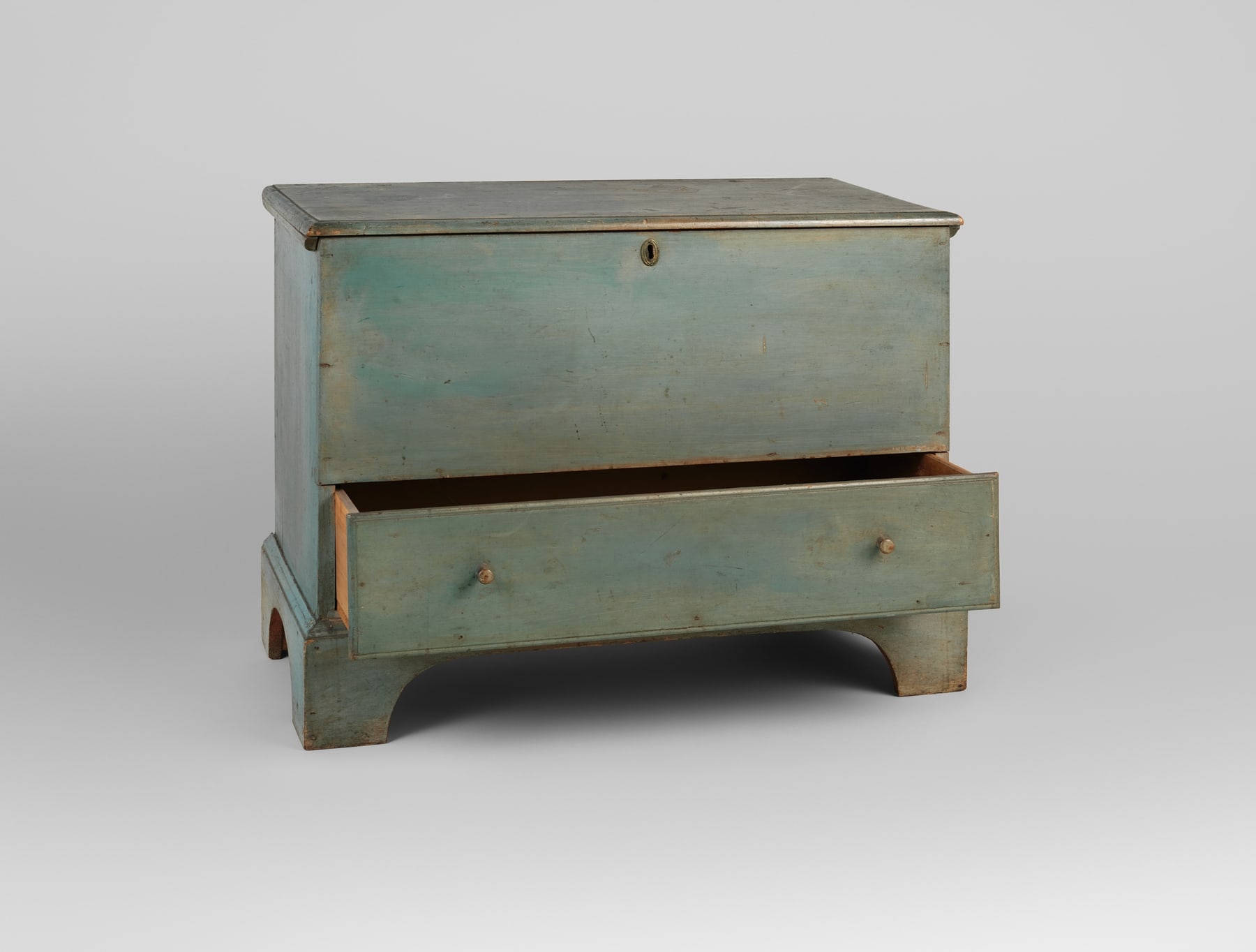 The blue Shaker chest with its lower drawer partly open, making the depth of this separate compartment visible.