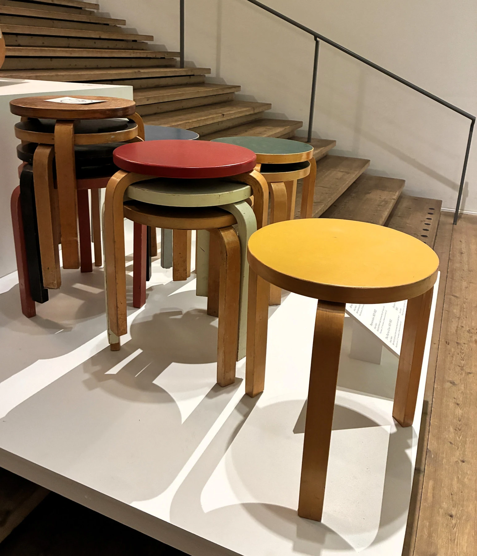 Overlapping coloured Aalto stools displayed beside a staircase at Millesgården.