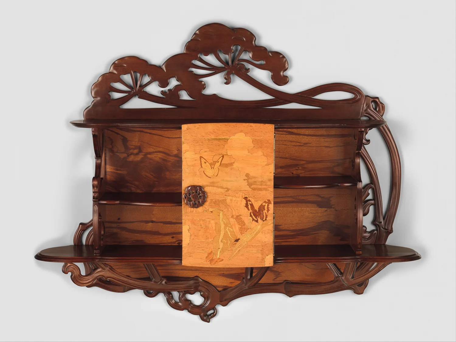 Gallé’s Ombellifères cabinet with a branching curved upper framework, side shelves and a marquetry door.