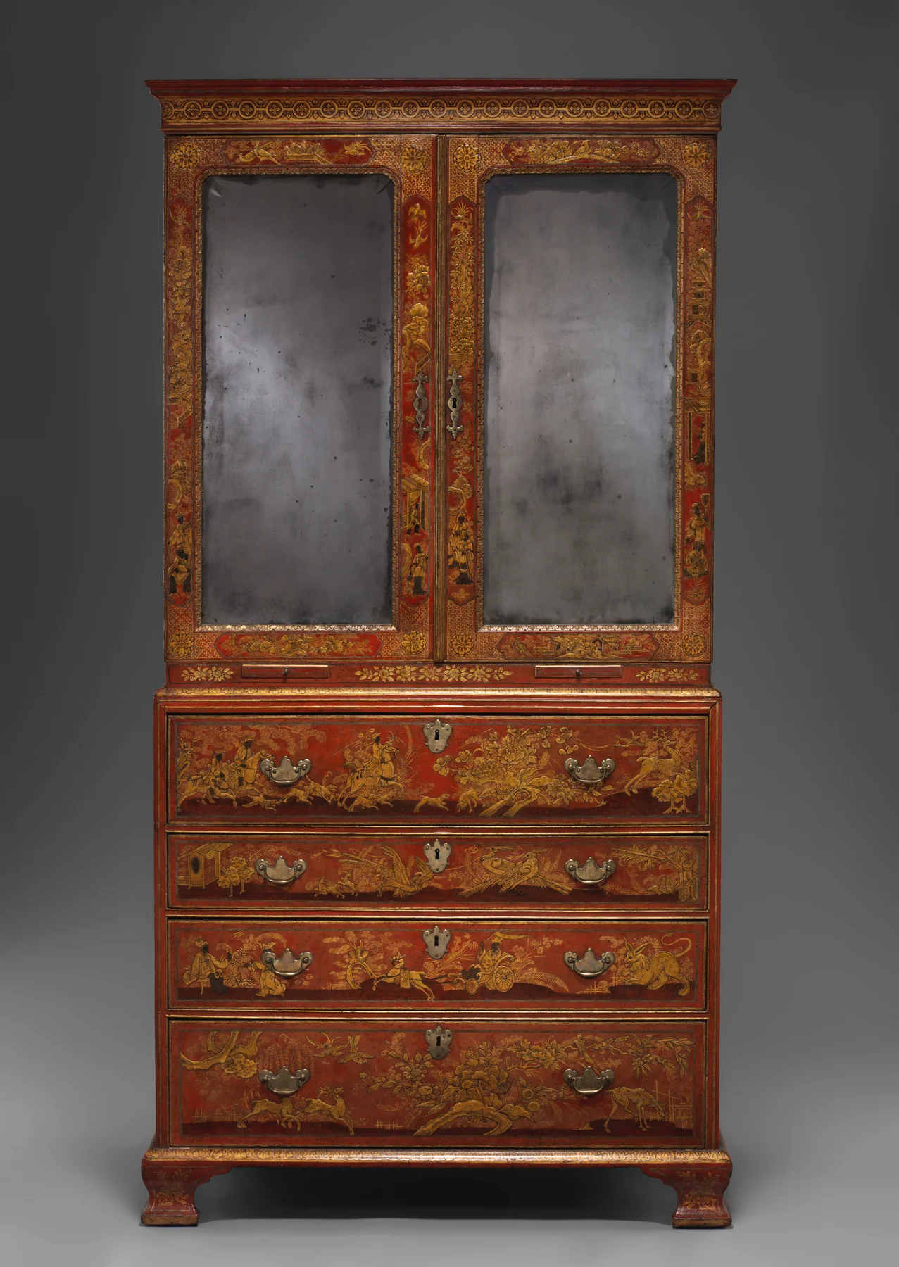 Full frontal view of the same red secretary cabinet closed, with two tall mirrored upper doors above four painted lower drawers.