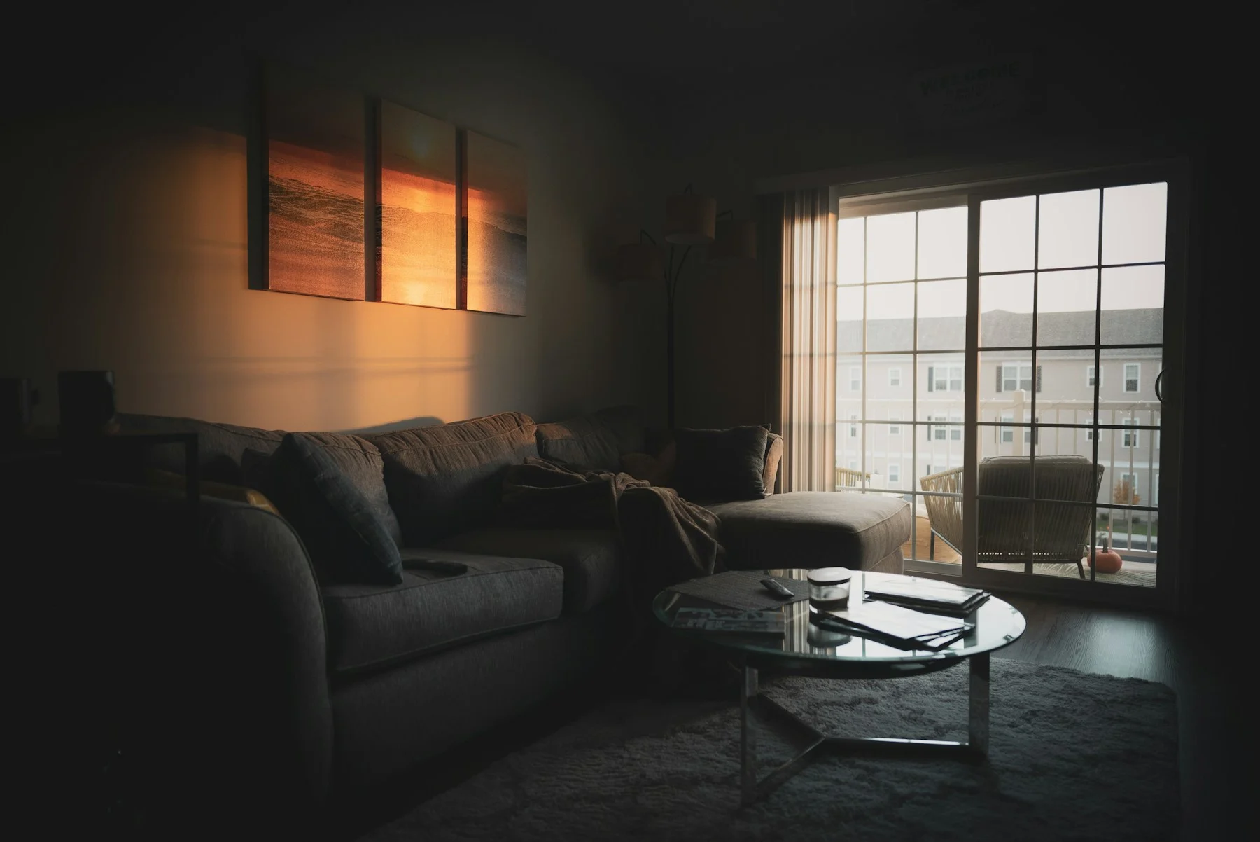 Grey L-shaped sectional sofa beside a window, with a chaise extending towards a coffee table.