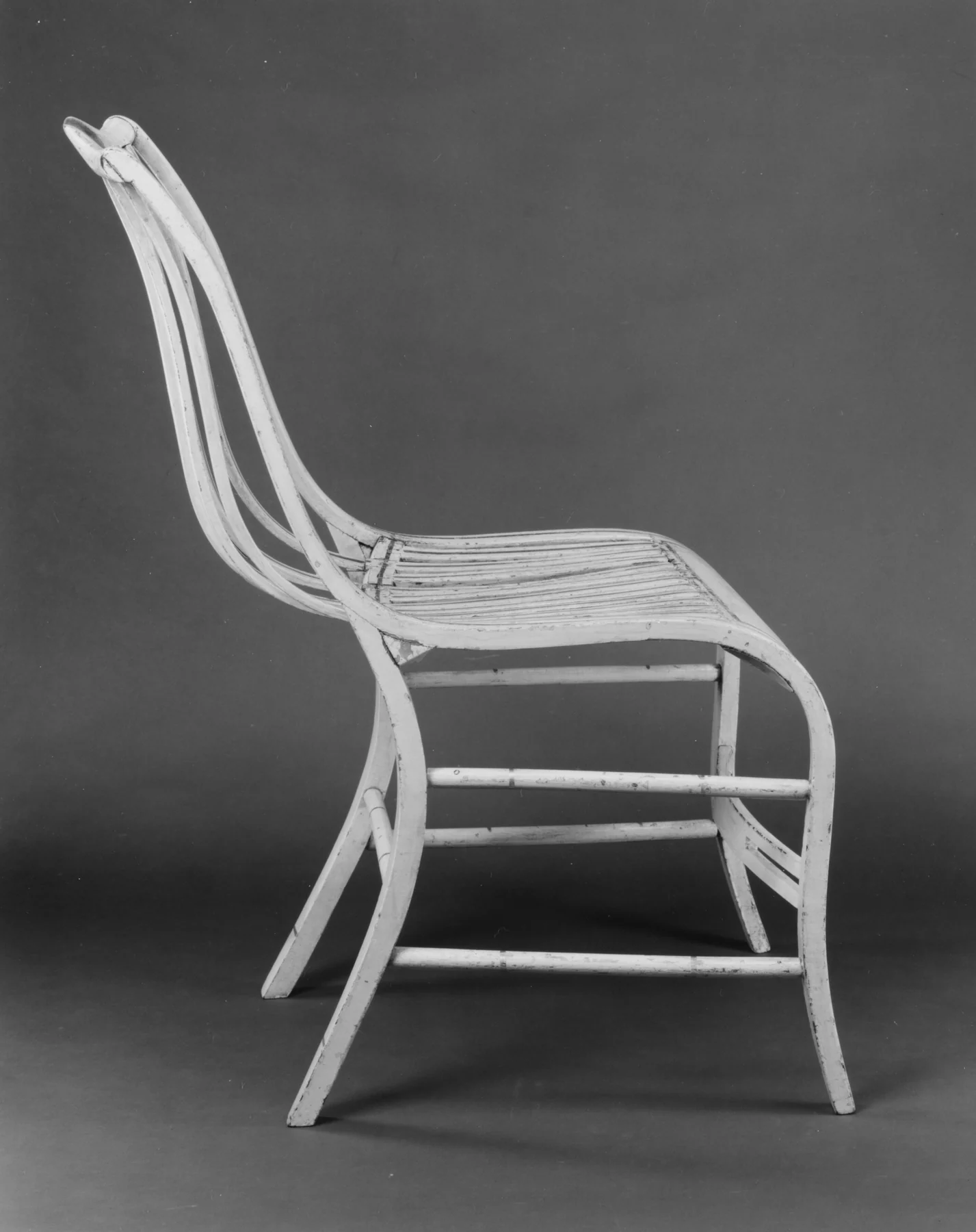 Archival side view of Gragg's chair showing one thin outer member sweeping from the back around the seat and down into the forward-curving front leg.