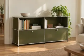 A low olive-green modular metal cabinet with two bays and open and closed compartments stands beside a cream sofa.