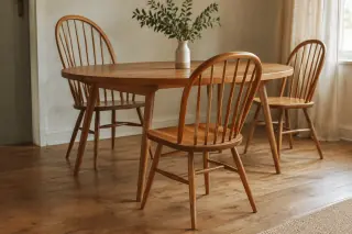 Wooden spindle-back chairs of different heights around an oval dining table.