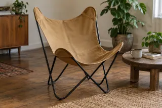 A tan sling supported at four corners by a dark butterfly-chair frame.
