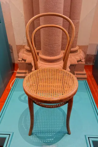 A full bentwood chair with a round woven cane seat viewed from slightly above.