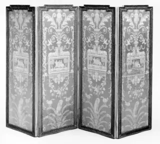 A four-leaf eighteenth-century folding screen shown in a shallow zigzag, with carved dark frames around tall patterned textile panels.