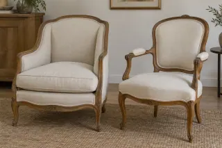 Two older-style wooden armchairs, one with upholstered enclosed sides and one with open arms.