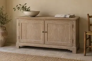 A pale oak-style cabinet with white grain contrast across its doors and top.