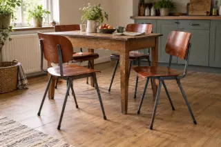 Wood and metal school-style chairs arranged around an everyday dining table.